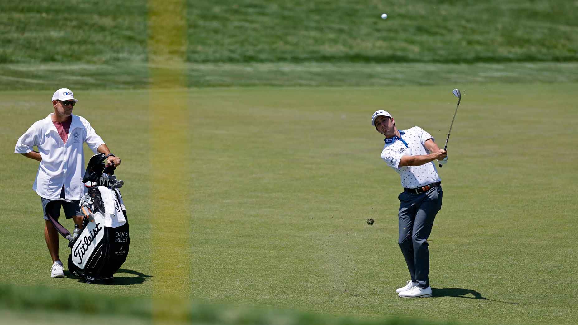 Pro golfer hits pitch shot during golf tournament