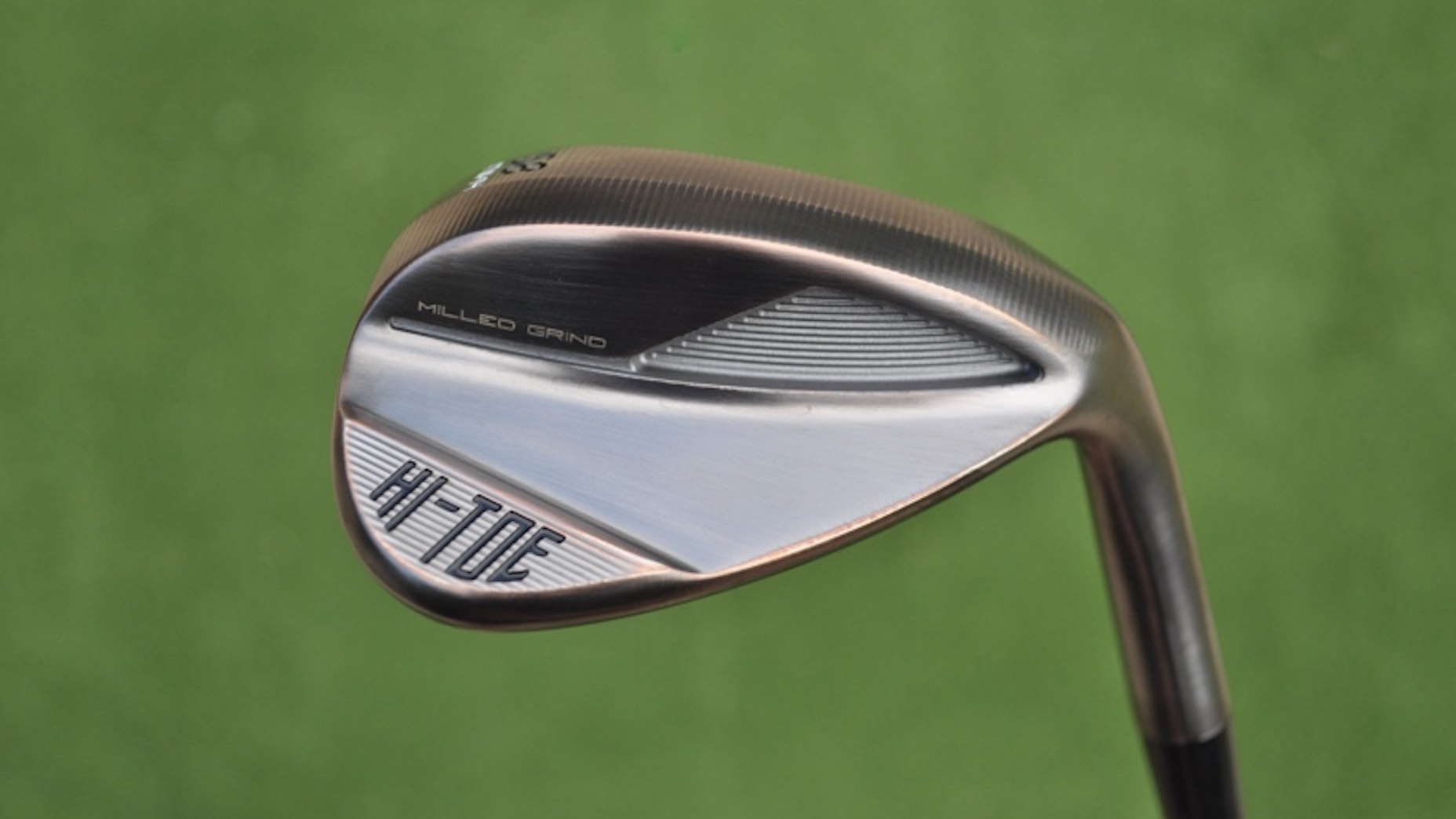 A TaylorMade Hi Toe 4 wedge pictured in hand at a golf course