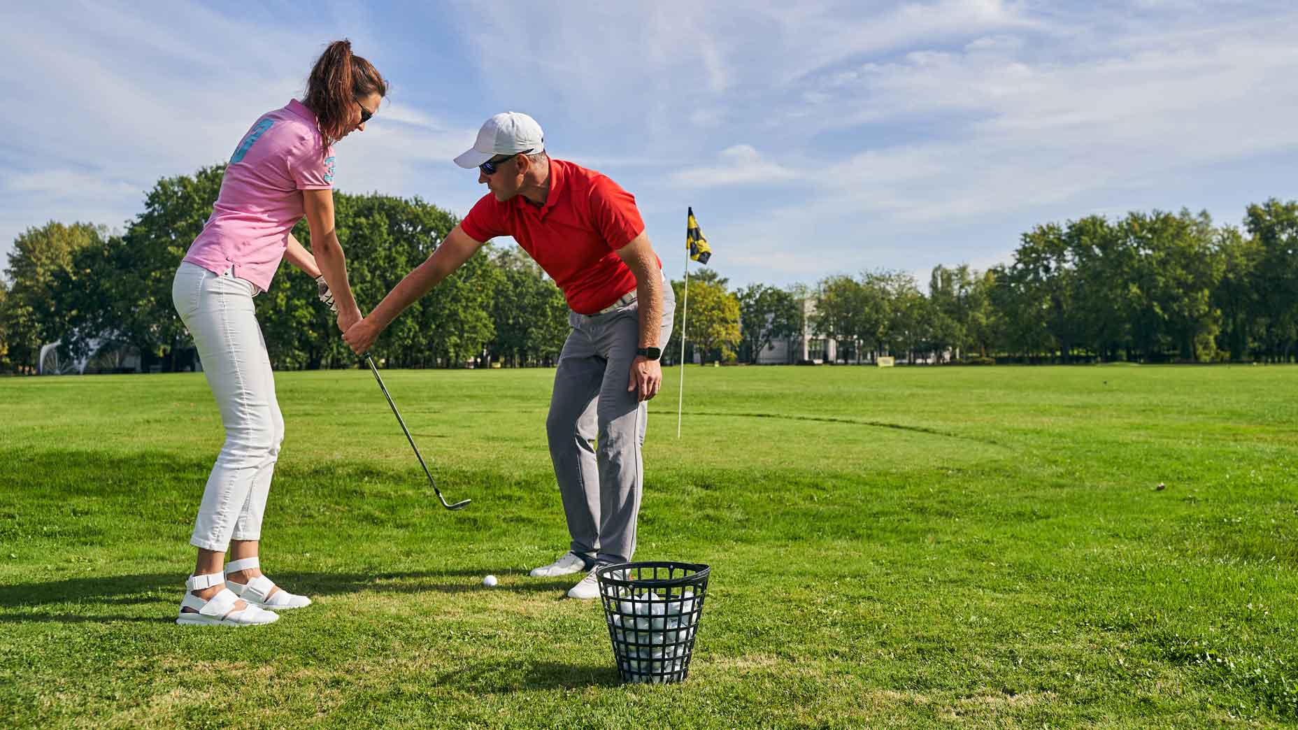 golf teacher gives pointers to student
