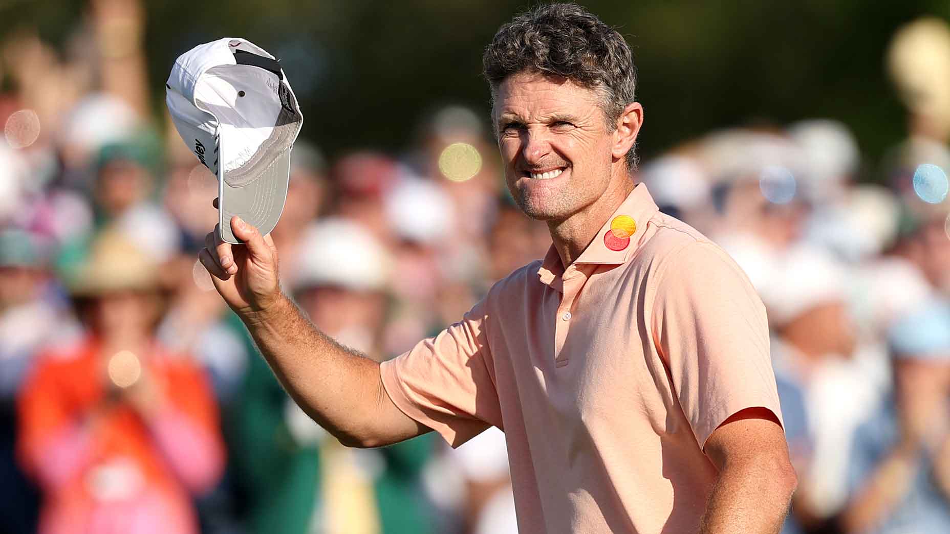 justin rose doffs his cap at the crowd during the final round of the 2025 masters