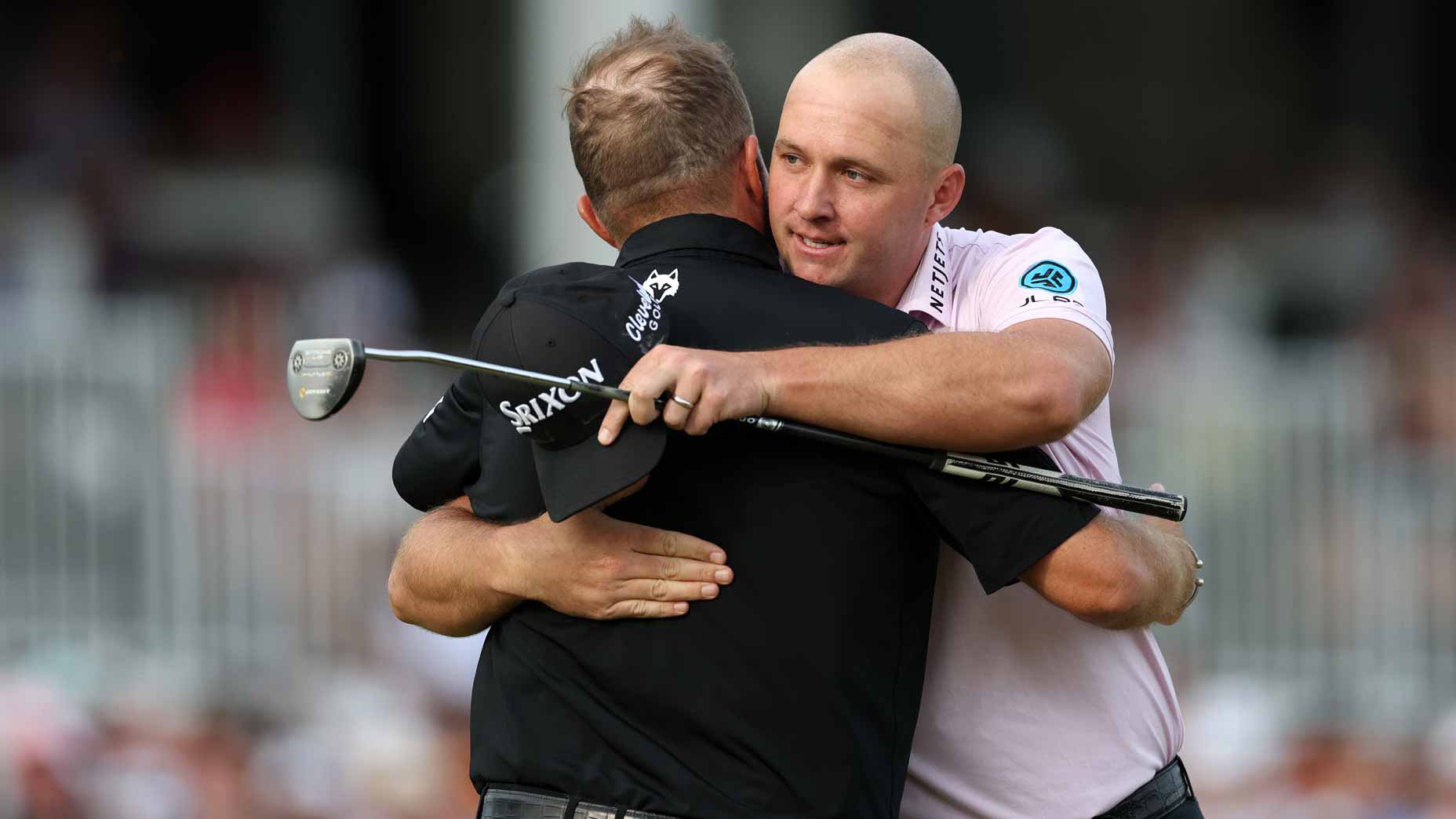 Sepp Straka hugs Shane Lowry after winning the Truist.