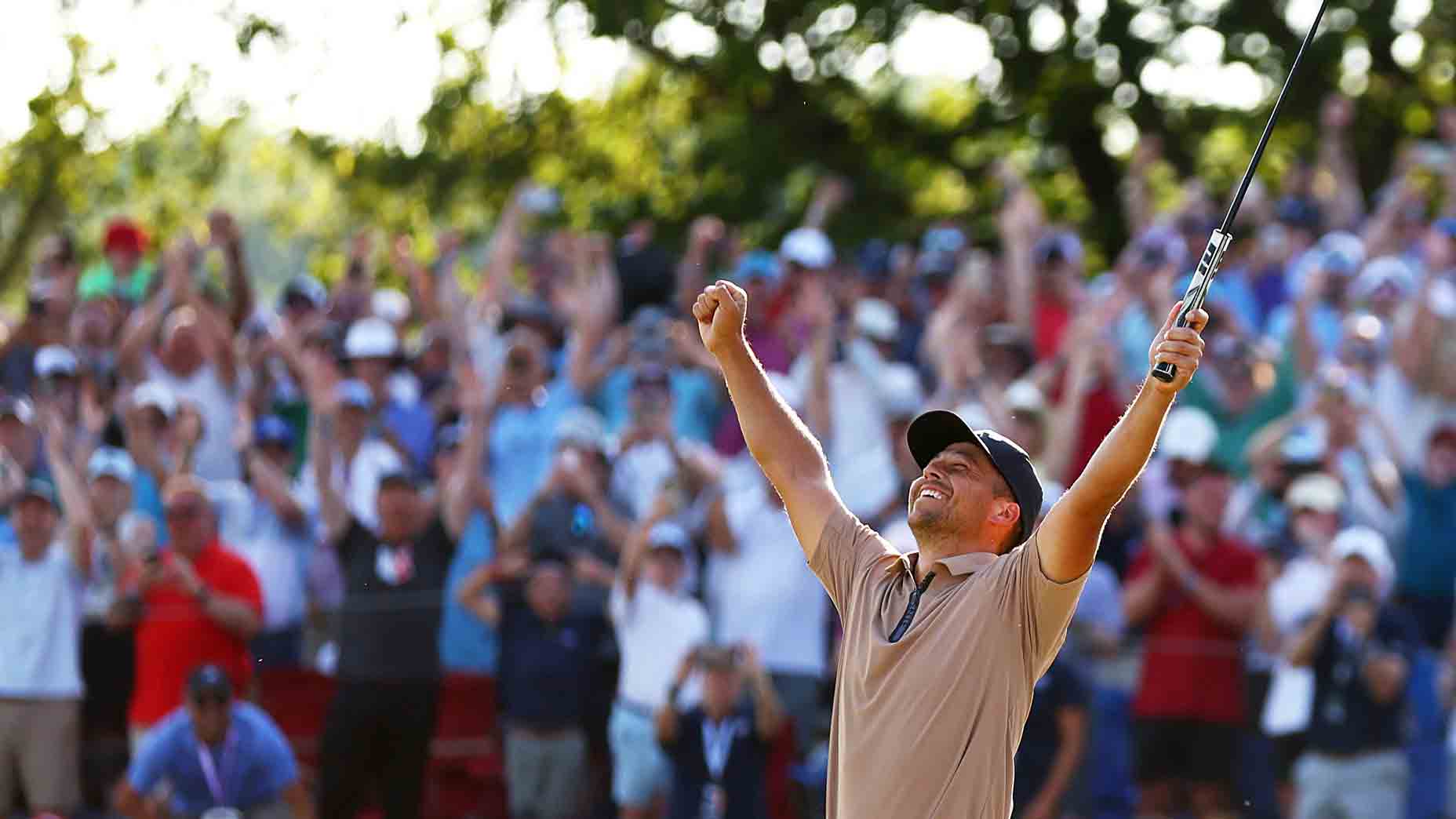 Xander Schauffele raies his arms after winning the PGA Championship