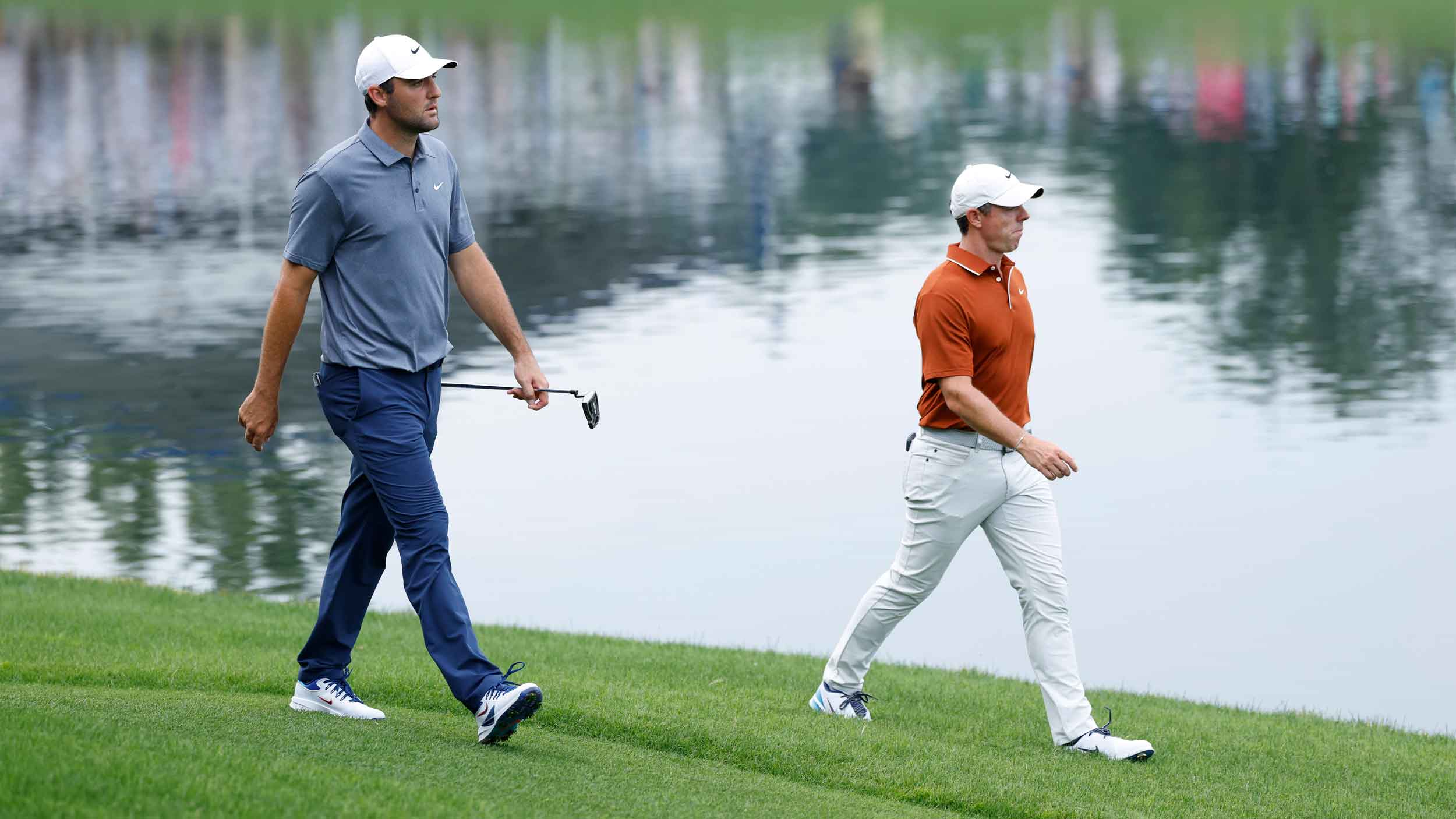 Scottie Scheffler (USA) and Rory McIlroy (NIR) walks to the green at the 17th hole during the second round of the PGA Championship at Quail Hollow