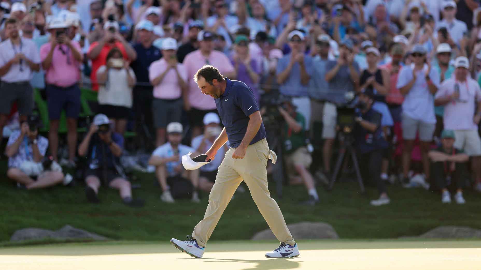 scottie scheffler screams after hitting winning putt at the pga championship in navy shirt