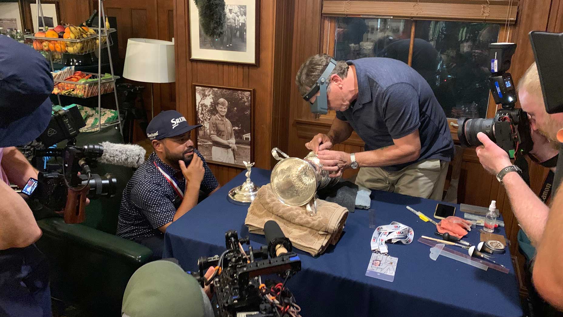 J.J. Spaun looks on as his name gets engraved into the U.S. Open trophy.