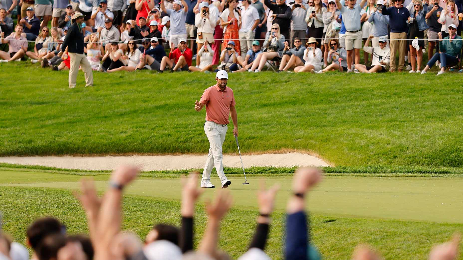 Scottie Scheffler waves to the crowd after making birdie on the 14th green during the third round of the Memorial Tournament.