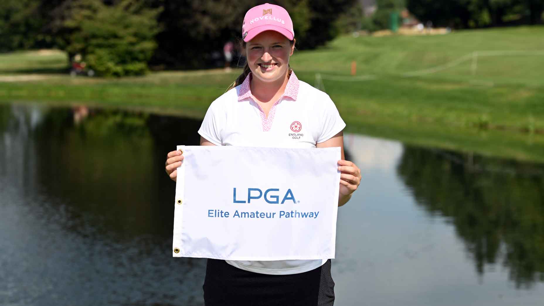 lottie woad poses with lpga flag at evian championship