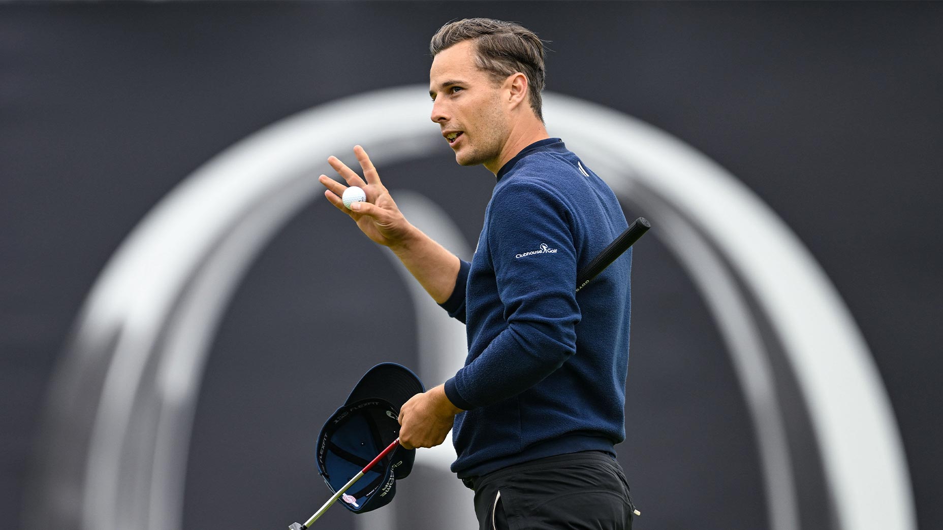 matthew jordan waves with hat off in blue sweater at the open championship