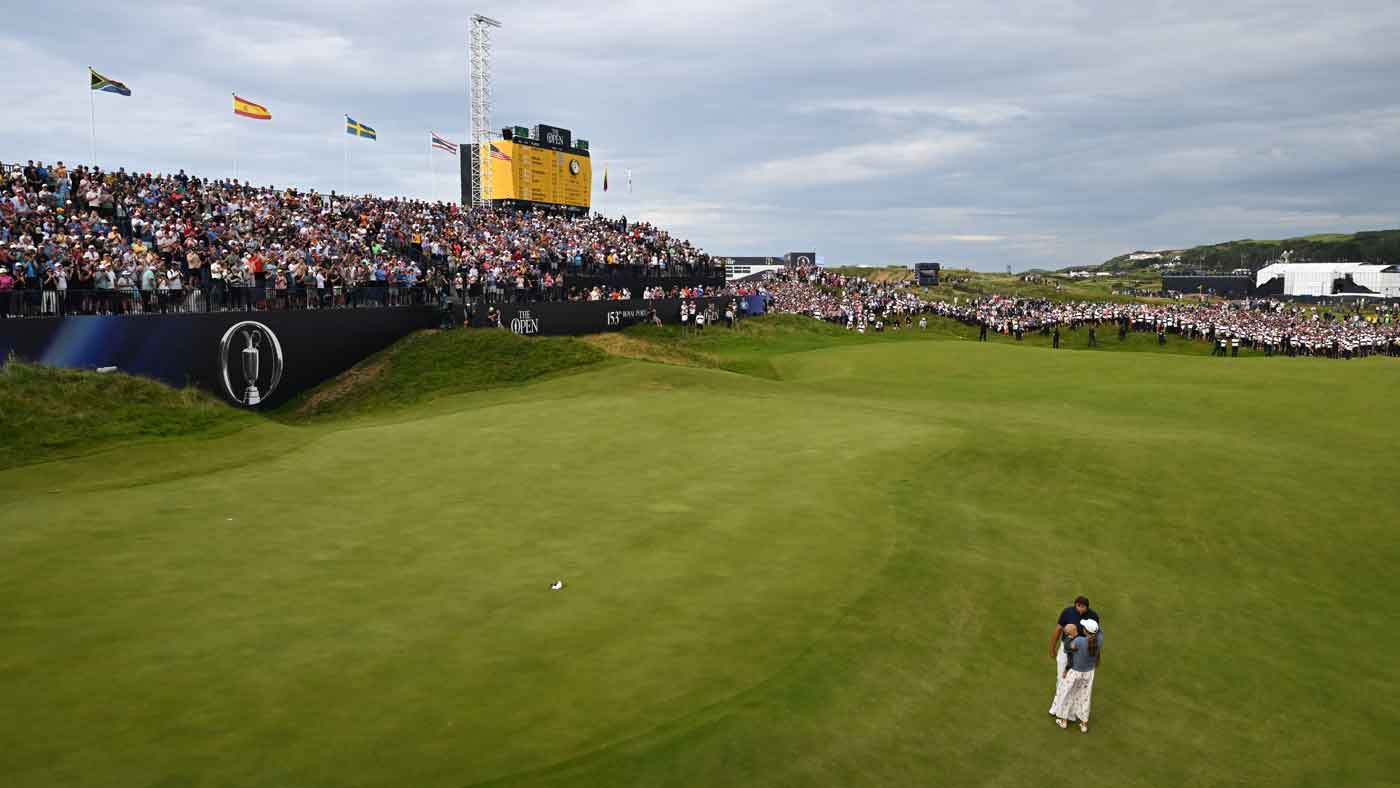 Scottie Scheffler of the United States celebrates victory on the 18th green with his wife Meredith Scheffler and son Bennett Scheffler on Day Four of The 153rd Open Championship a