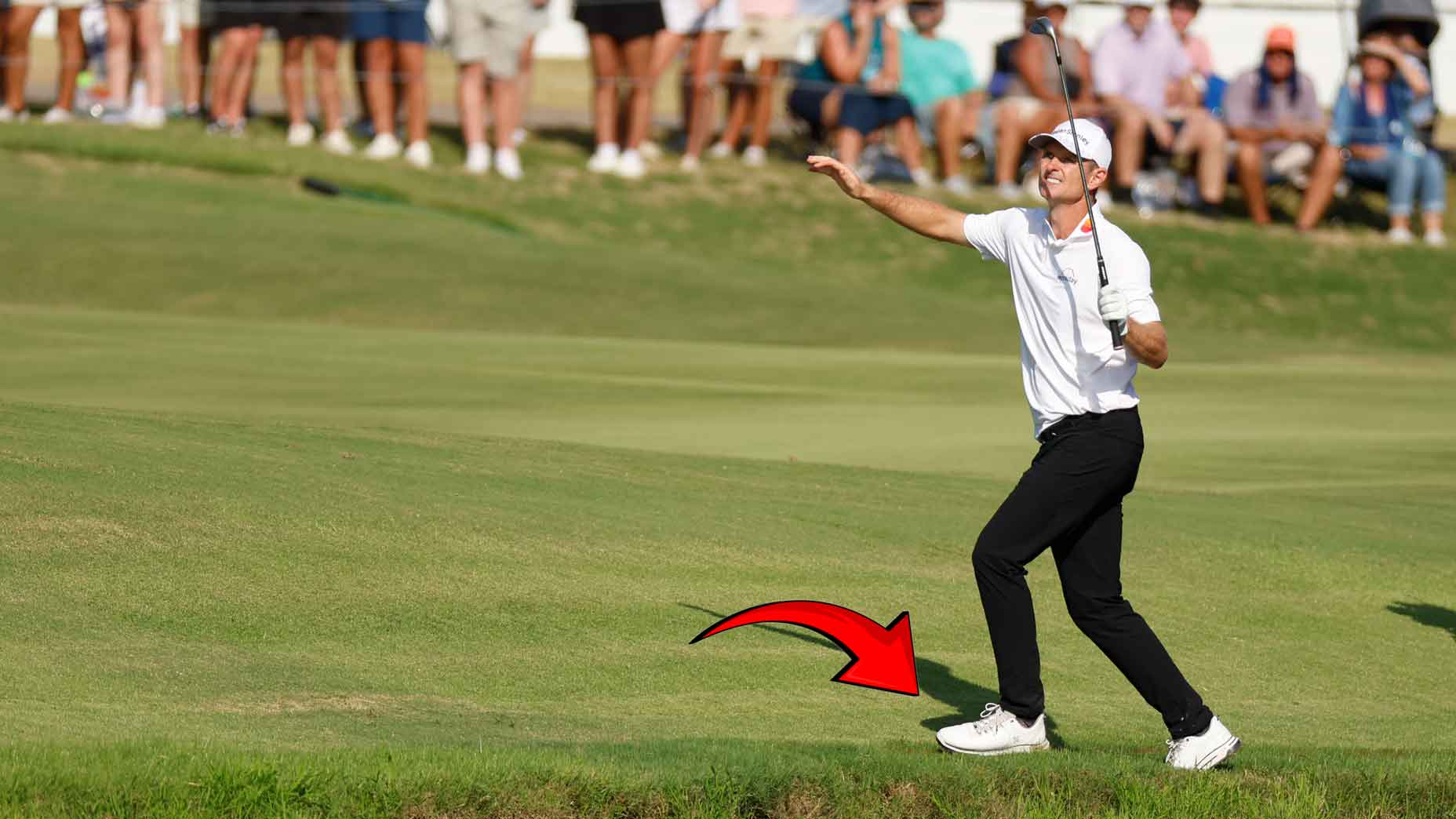 Justin Rose regains his balance after hitting a shot.
