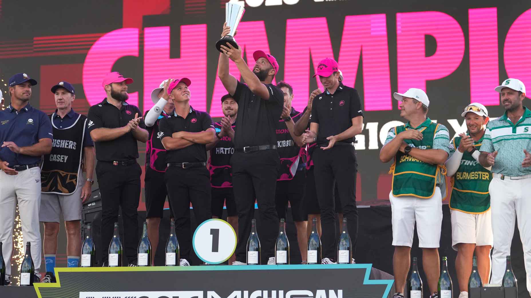 legion xiii celebrates winning the liv team championship atop the podium