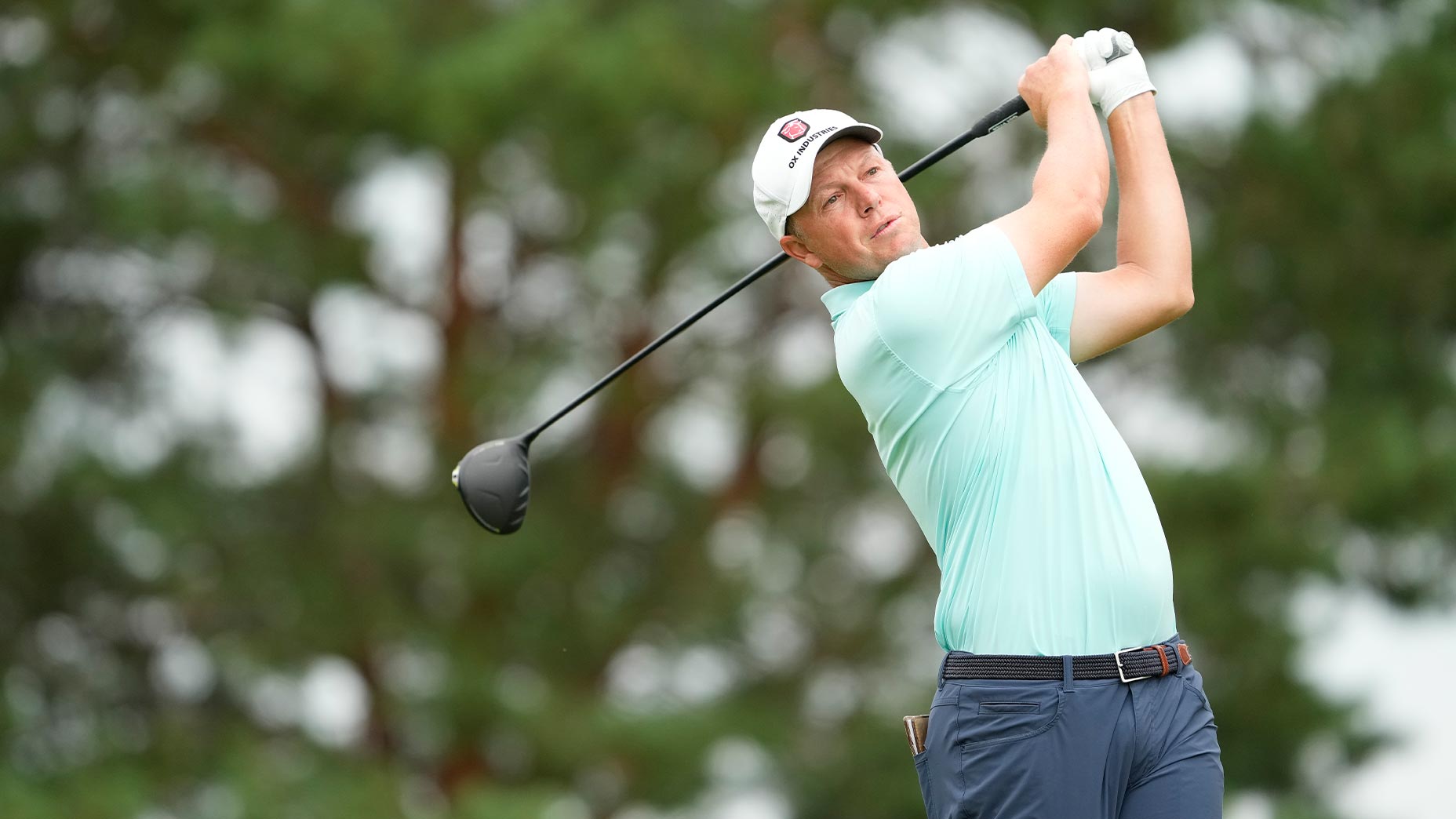 mj daffue swings driver at a korn ferry tour event in coral shirt