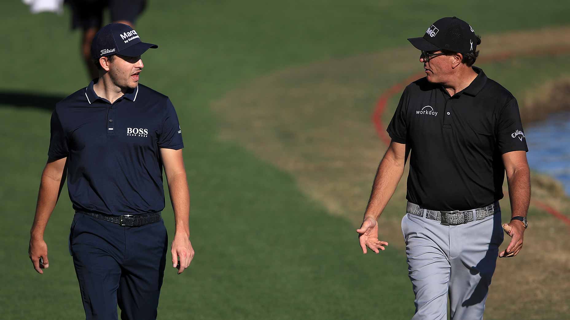 Phil Mickelson and Patrick Cantlay and walk during the first round of the 2021 American Express.