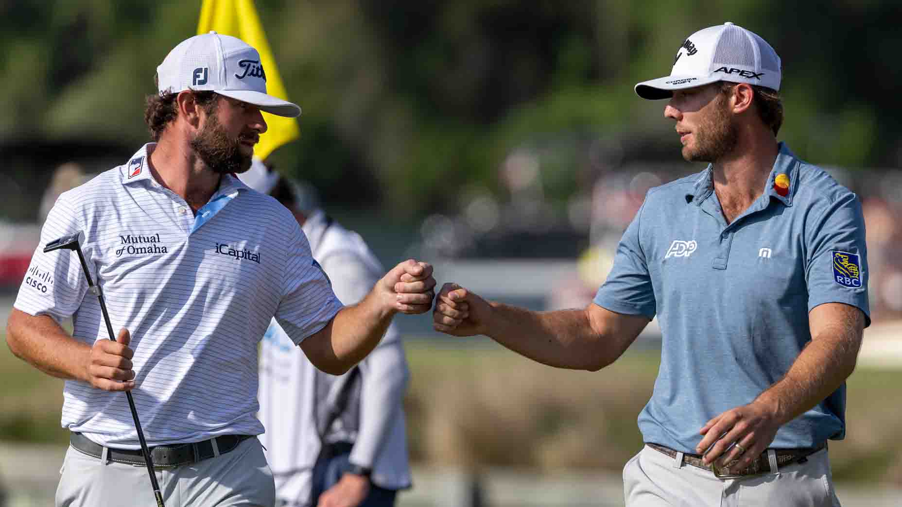 Sam Burns and Cameron Young bump fists at the 2023 WGC Dell Technologies Match Play Championship