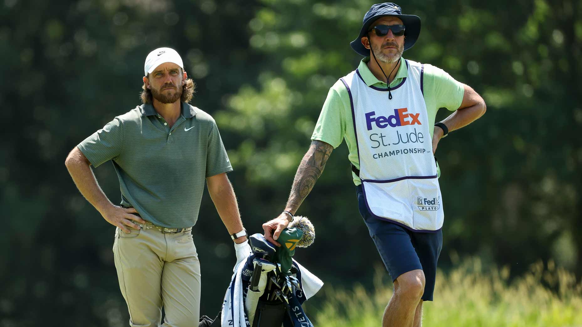 Tommy Fleetwood of England and his caddie Ian Finnis look on while playing the second hole during the third round of the FedEx St. Jude Championship 2025 at TPC Southwind on August 09, 2025 in Memphis, Tennessee