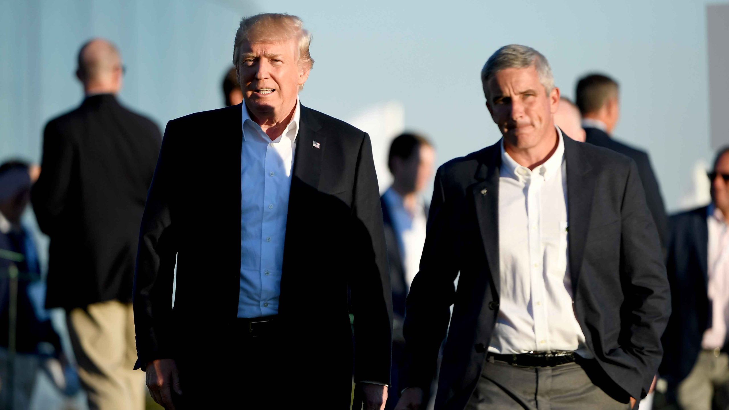 President Donald Trump walks with Jay Monahan, PGA TOUR Commissioner, after the U.S. Team defeated the International Team 19 to 11 in the Presidents Cup at Liberty National Golf Club