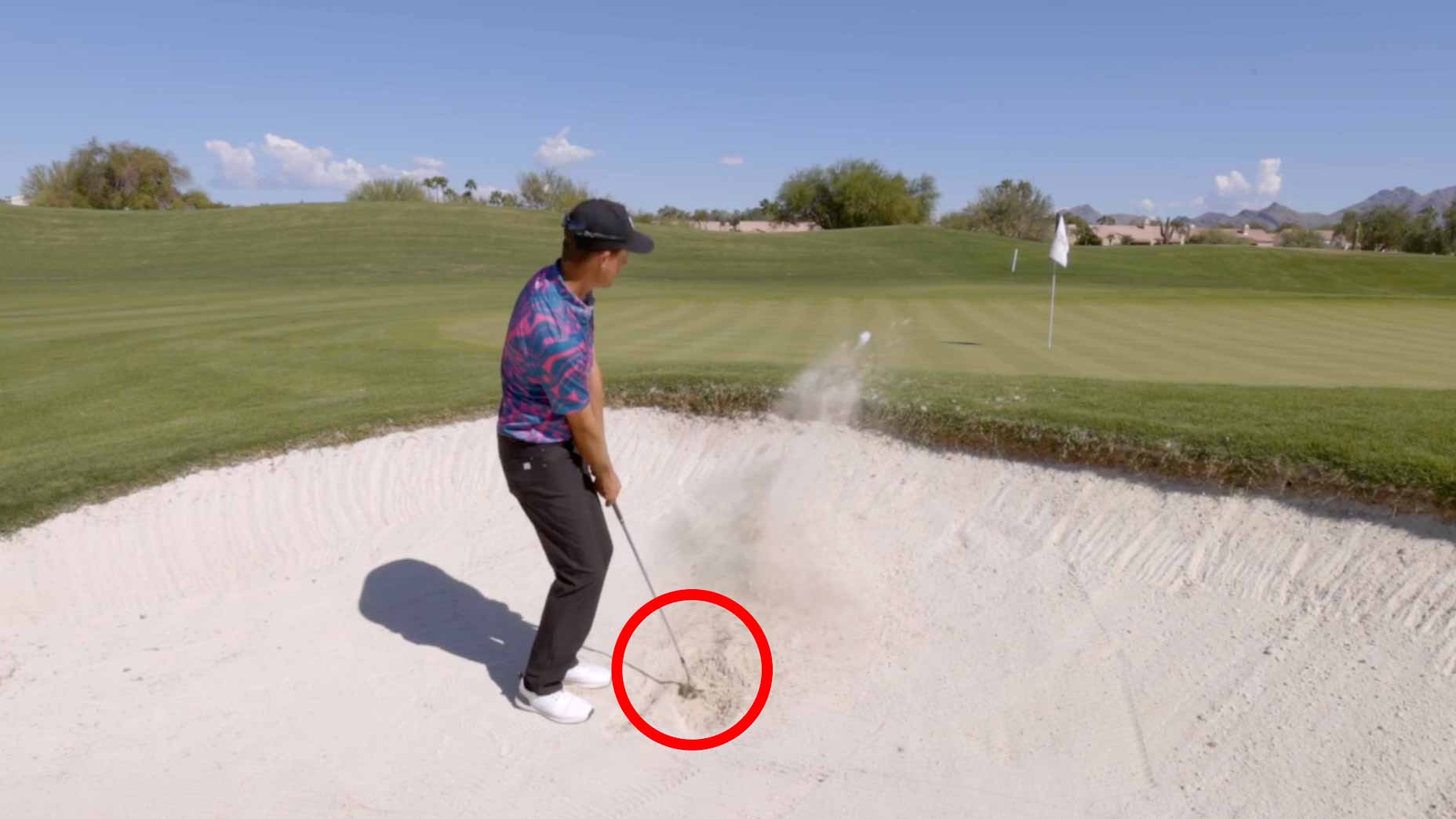 Parker McLachlin demonstrates how to hit a fried egg bunker shot