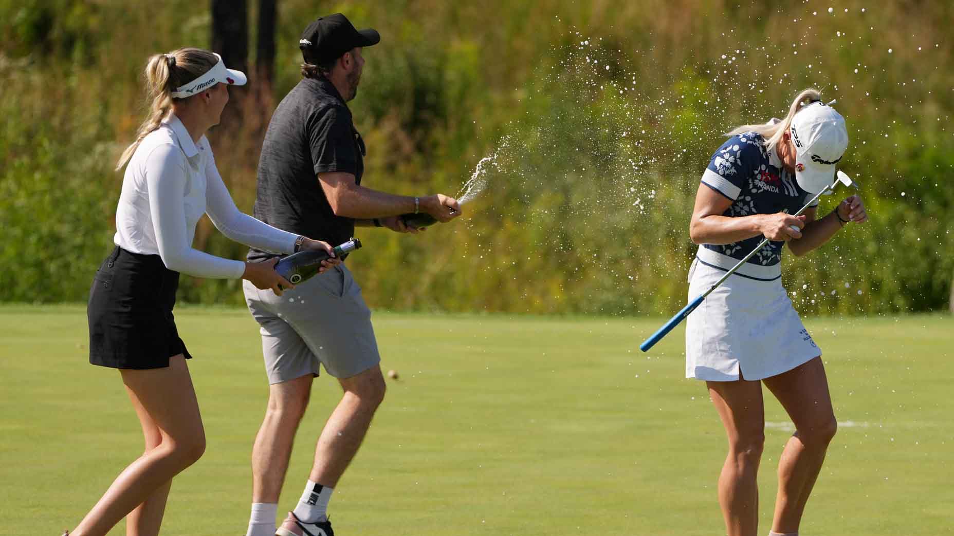 Charley Hull is sprayed with champagne after winning the Kroger Queen City Championship
