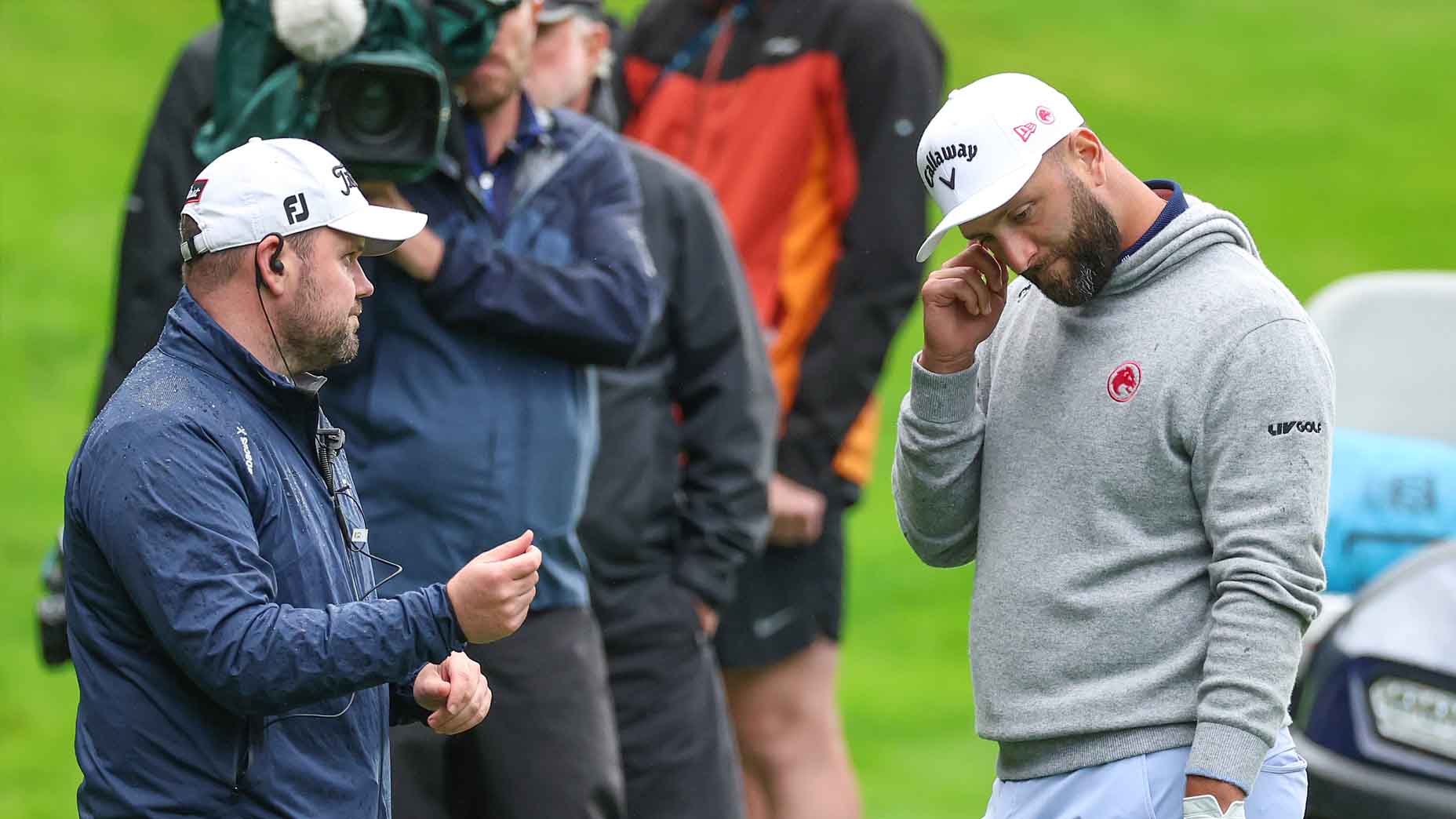 Jon Rahm discusses a ruling with an official during the BWM PGA Championship