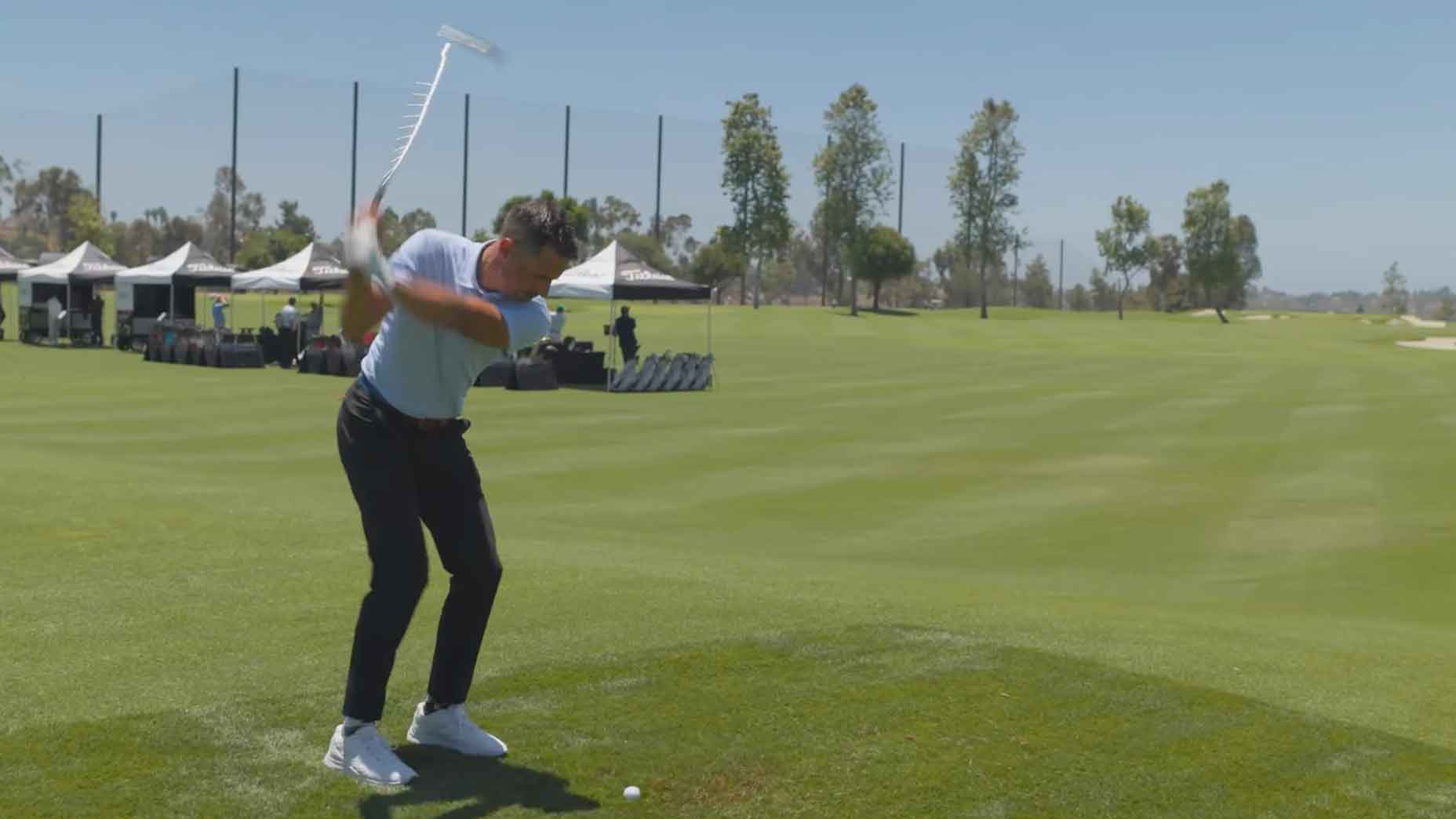 johnny wunder hits golf ball at titleist performance institute