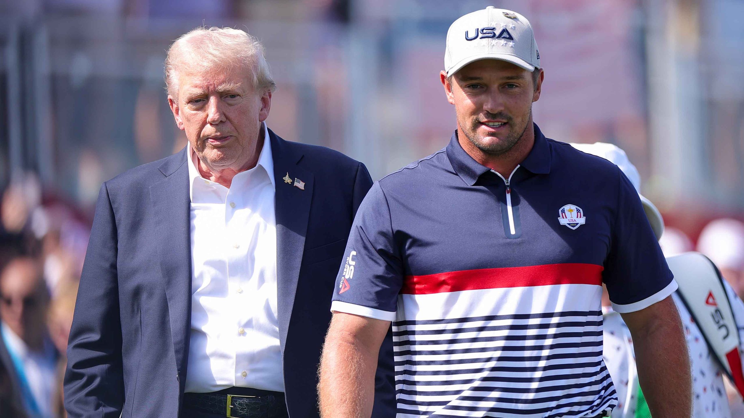 U.S. President Donald Trump walks with pro-golfer Bryson DeChambeau as he attends the 2025 Ryder Cup at Black Course at Bethpage State Park Golf Course
