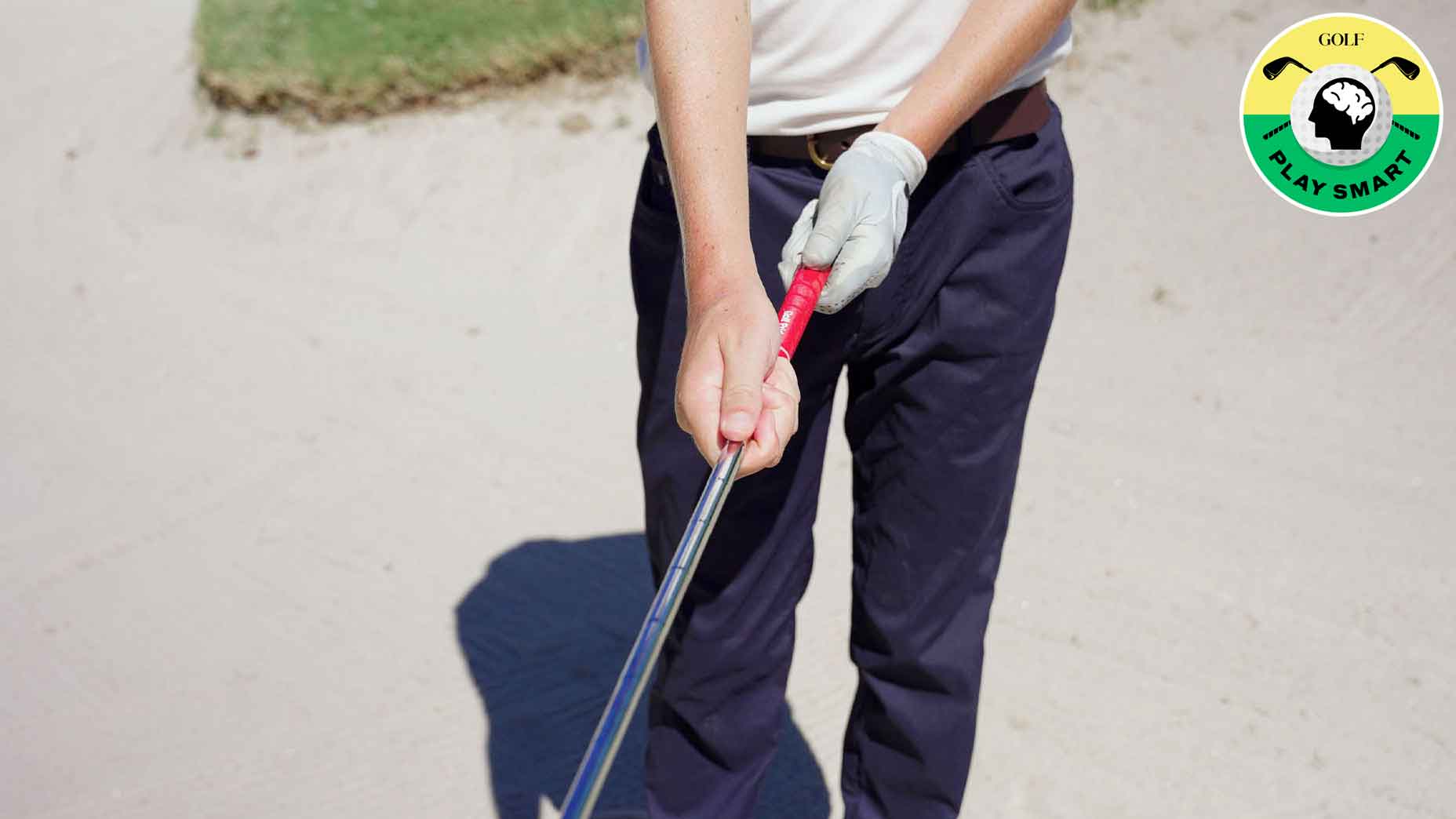 GOLF.com editor zephyr melton holds golf club with two hands in the bunker