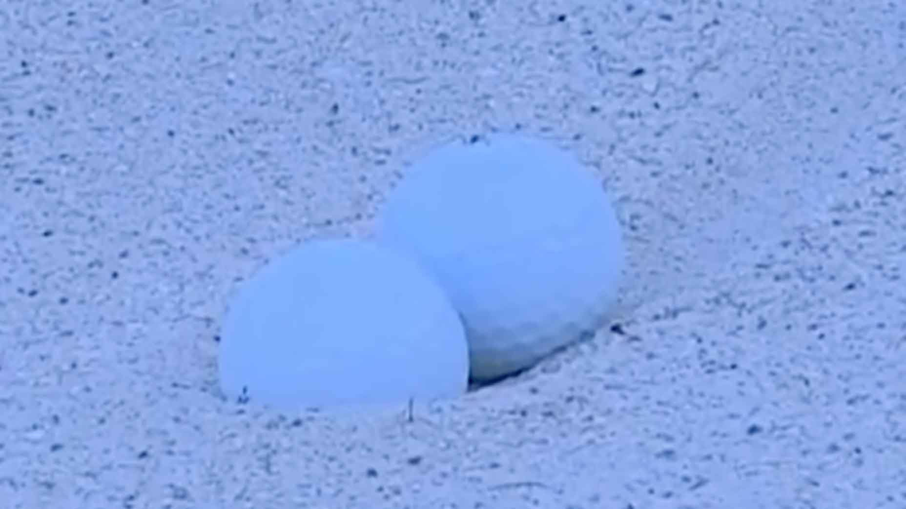 golf balls touching in bunker