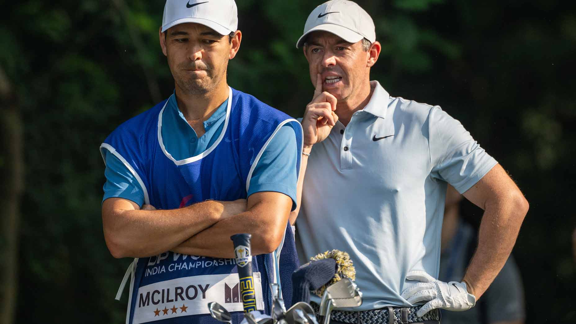 Rory McIlroy talks with his caddie on Thursday at the 2025 DP World India Championship.