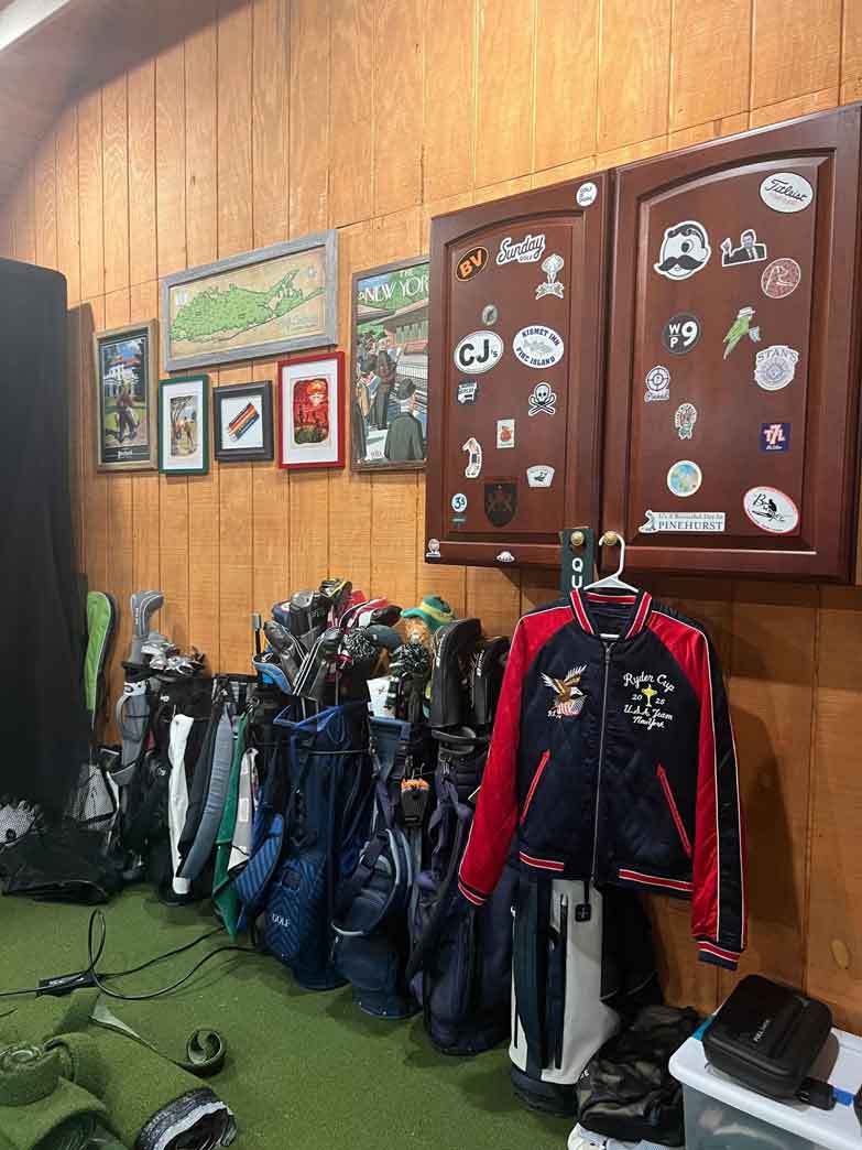 A view of the author's DIY golf bag rack, repurposed cabinet, and artwork.
