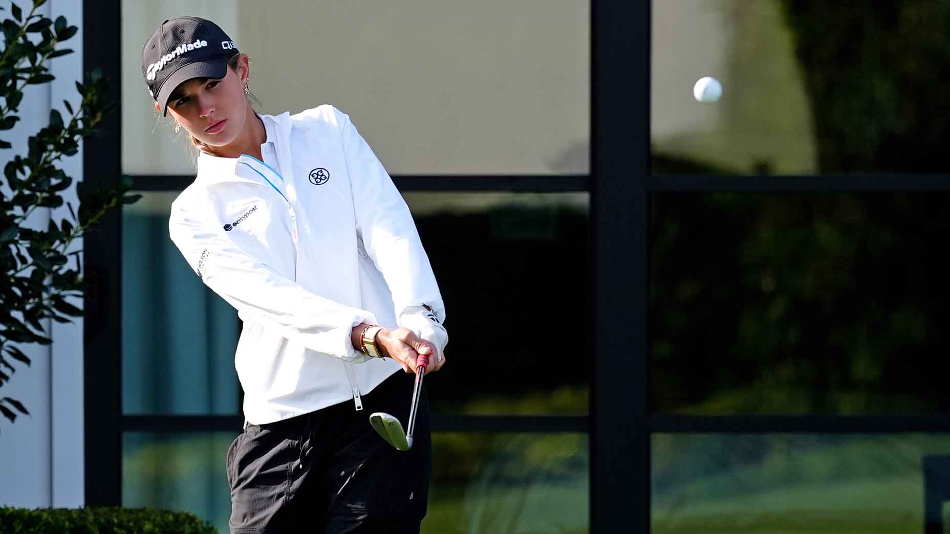 Kai Trump hits a practice shot at Pelican Golf Club