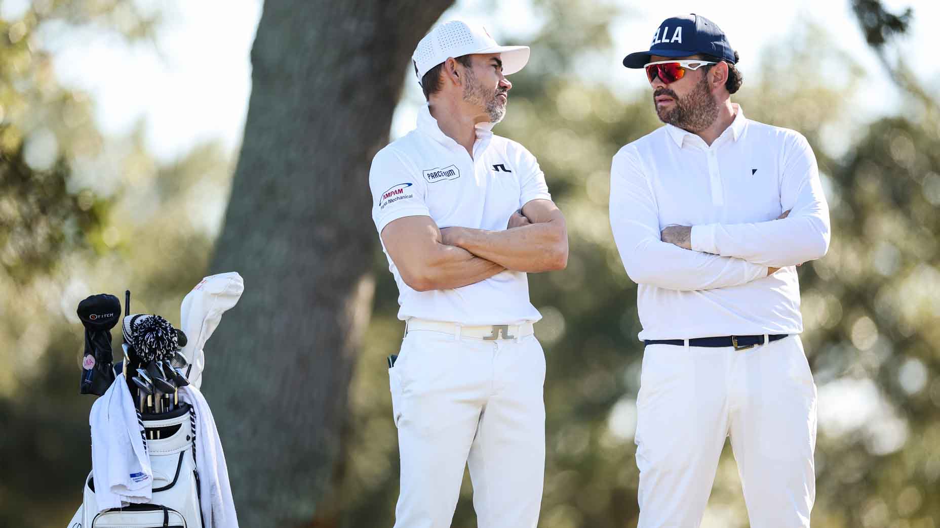Camilo Villegas and Marcelo Roza talk during the third round of Q School