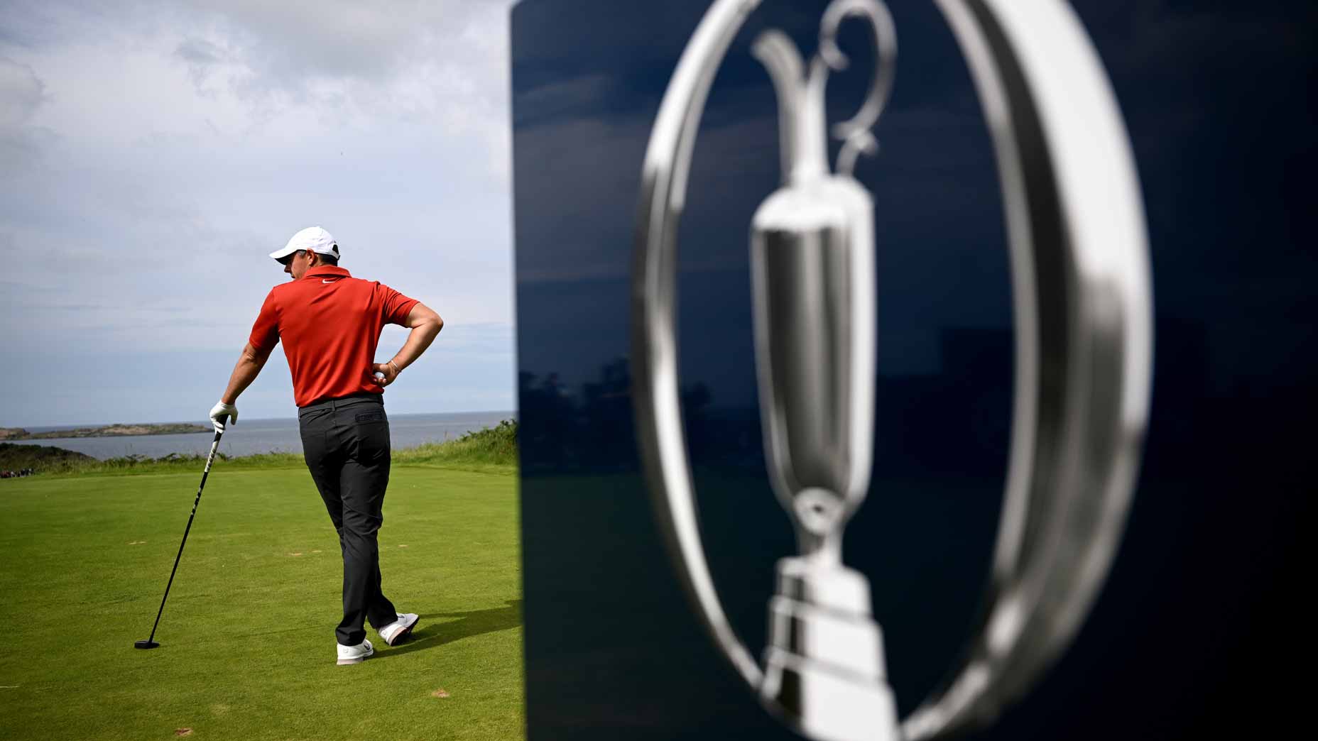The Open Championship logo is seen as Rory McIlroy stands on tee at 2025 Open Championship at Royal Portrush.